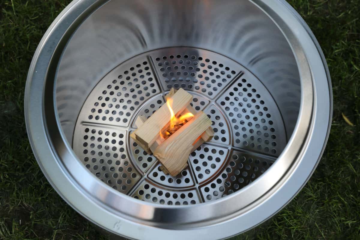 Solo stove bonfire with kindling and a firestarter inside.