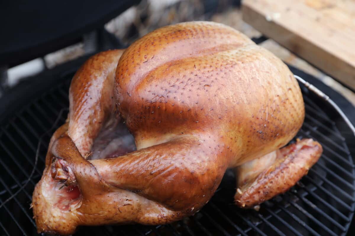 Close up of a whole smoked turkey on a kamado Joe smoker.