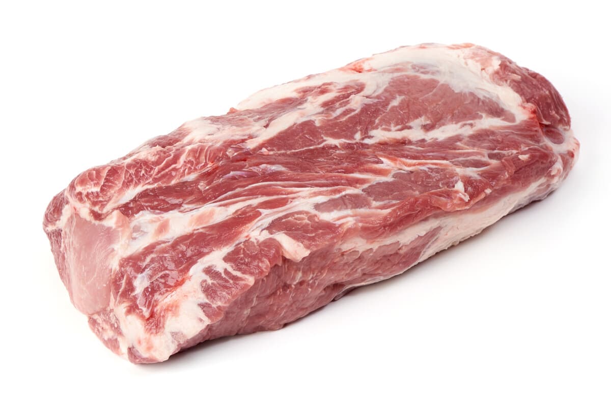 A raw pork butt money muscle isolated on white.