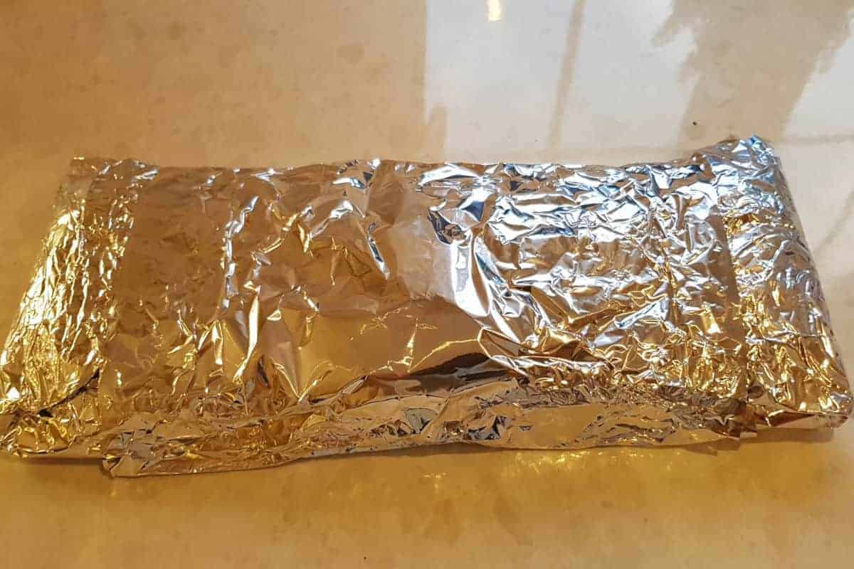 Foil wrapped ribs on a kitchen coun.