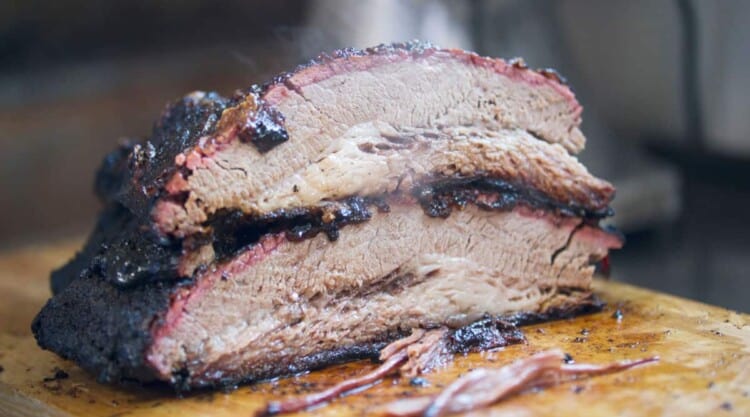 Smoked brisket, sliced in two with one half on top of the other.